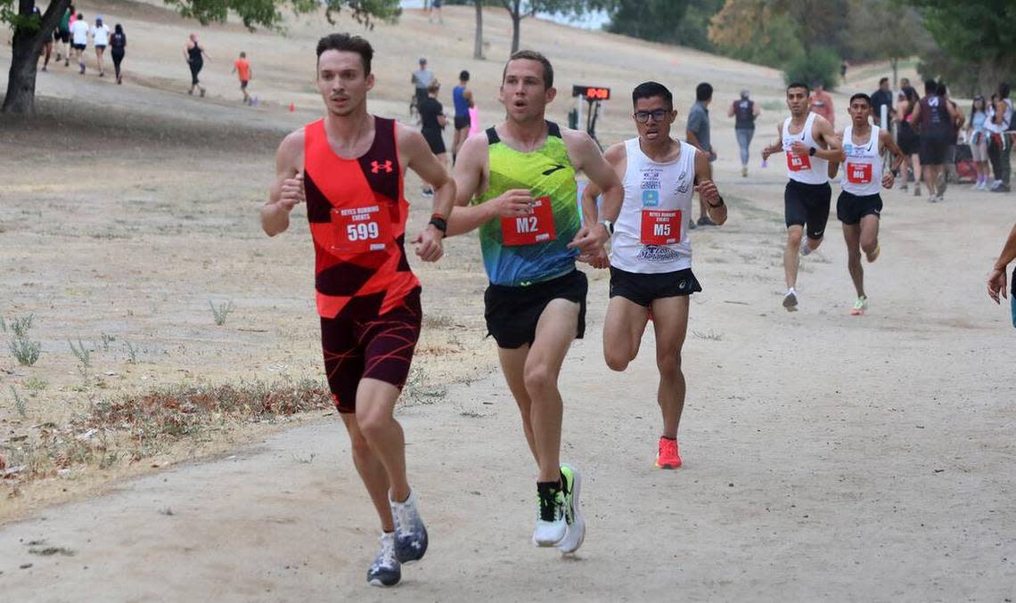 Kasey Knevelbaard, CJ Albertson and Hesiquio Flores Romero get past the 2-mile mark at the Miguel Reyes 5K at Woodward Park on July 31, 2022.