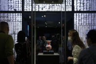 Visitors tour the Hong Kong Palace Museum during the first day open to public in Hong Kong, Sunday, July 3, 2022. The museum showcases more than 900 Chinese artefacts, loaned from the long-established Palace Museum in Beijing, home to works of art representing thousands of years of Chinese history and culture.(AP Photo/Kin Cheung)