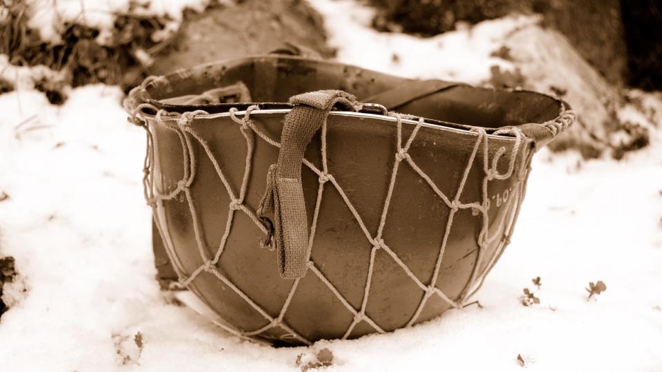 An American soldier's helmet lies on the ground at the Battle of the Bulge.