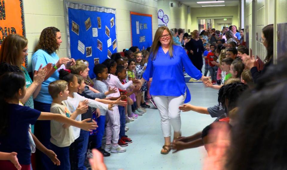 Nicole Radney, who teaches second grade at Mathews Elementary School in Columbus, center, was notified in her classroom Friday morning that she is one of three finalists for Muscogee County School District 2023 Teacher of the Year. 04/14/2023