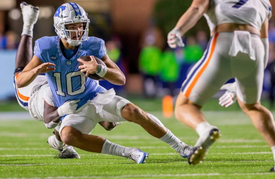 North Carolina quarterback Drake Maye (10) is sacked by Virginia’s Ben Smiley III (10) for a two yard loss in the fourth quarter on Saturday, October 21, 2023 at Kenan Stadium in Chapel Hill, N.C.