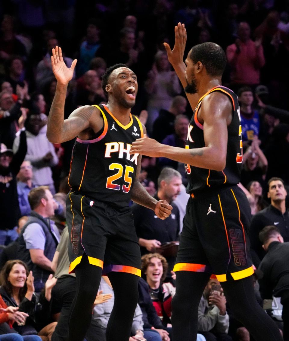 Phoenix Suns forward Nassir Little (25) high-fives forward Kevin Durant (35) after making a basket against the Denver Nuggets in the second half at Footprint Center in Phoenix on Dec. 1, 2023.