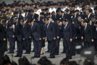 Chinese President Xi Jinping, center, and other officials bow during a ceremony to mark Martyr's Day at Tiananmen Square in Beijing, Monday, Sept. 30, 2019. Xi led other top officials in paying respects to the founder of the communist state Mao Zedong ahead of a massive celebration of the People's Republic's 70th anniversary. (AP Photo/Mark Schiefelbein, Pool)