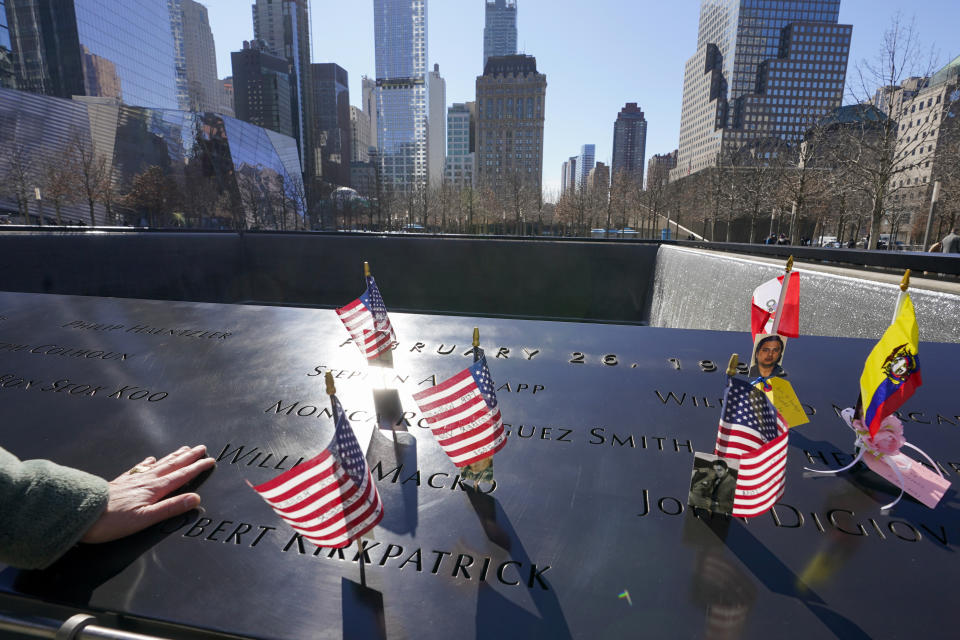 Sgt. Edwin Morales pays his respects to the victims of the 1993 bombing World Trade Center before the start of a ceremony marking the 28th anniversary of the attack, Friday, Feb. 26, 2021, in New York. On Feb. 26, 1993, a truck bomb built by Islamic extremists exploded in the parking garage of the North Tower of the World Trade Center, killing six people and injuring more than 1,000 others. (AP Photo/Mary Altaffer)