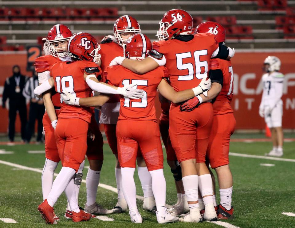 Crimson Cliffs’ players huddle on the field as the clock runs down, after Steele Barben took a knee, in the final minute of a 4A semifinal football game against Ridgeline at Rice-Eccles Stadium in Salt Lake City on Friday, Nov. 10, 2023. Crimson Cliffs won 31-24.