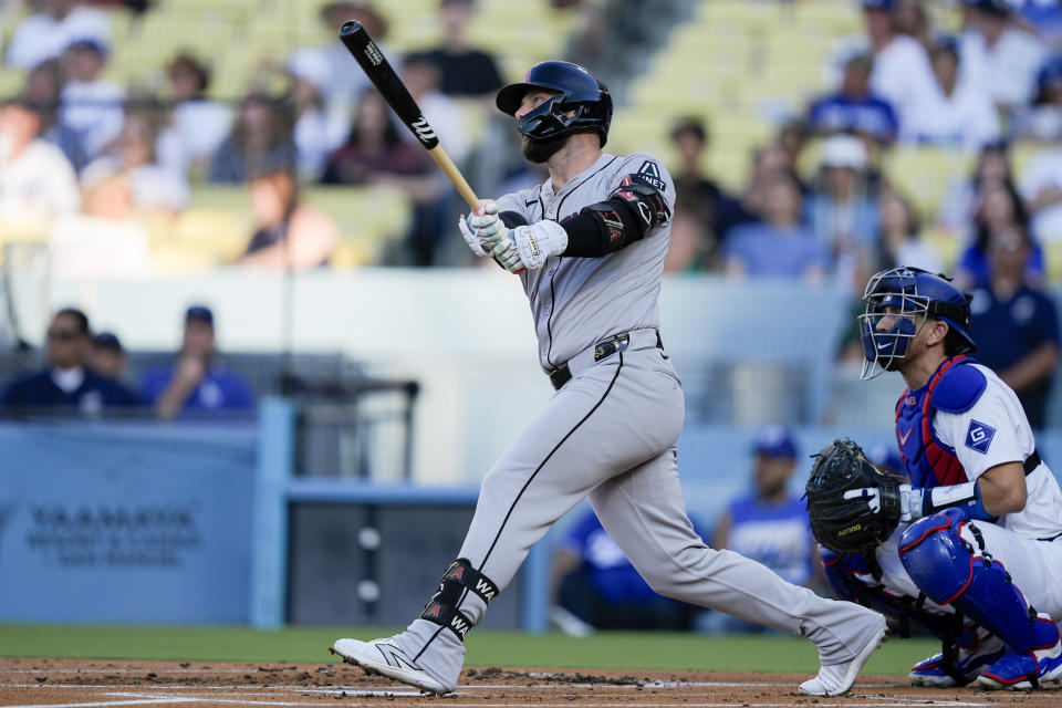 Arizona Diamondbacks' Christian Walker, left, watches his solo home run during the first inning of a baseball game against the Los Angeles Dodgers, Thursday, July 4, 2024, in Los Angeles. (AP Photo/Ryan Sun)