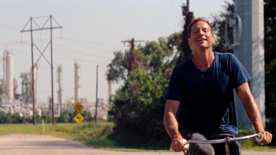 Simon Rex riding a bike