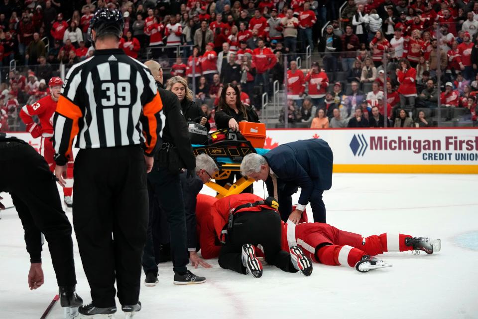 Detroit Red Wings center Dylan Larkin (71) is helped by medical staff after being hit against the Ottawa Senators in the first period at Little Caesars Arena on Saturday, Dec. 9, 2023.