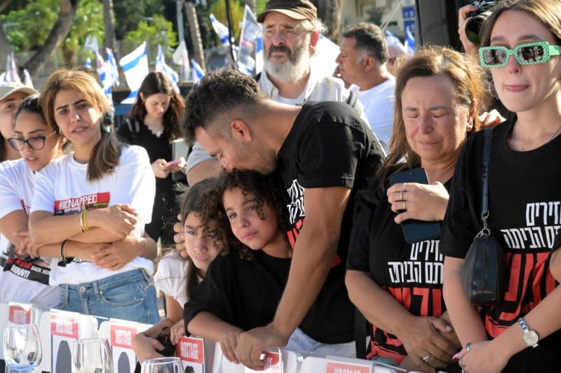 Families of hostages held by Hamas in Gaza welcome the Shabbat, the Jewish Sabbath, at a symbolic table with 203 empty chairs. The display was set up near the Tel Aviv Museum on Friday and was observed globally, as well. Photo by Debbie Hill/UPI