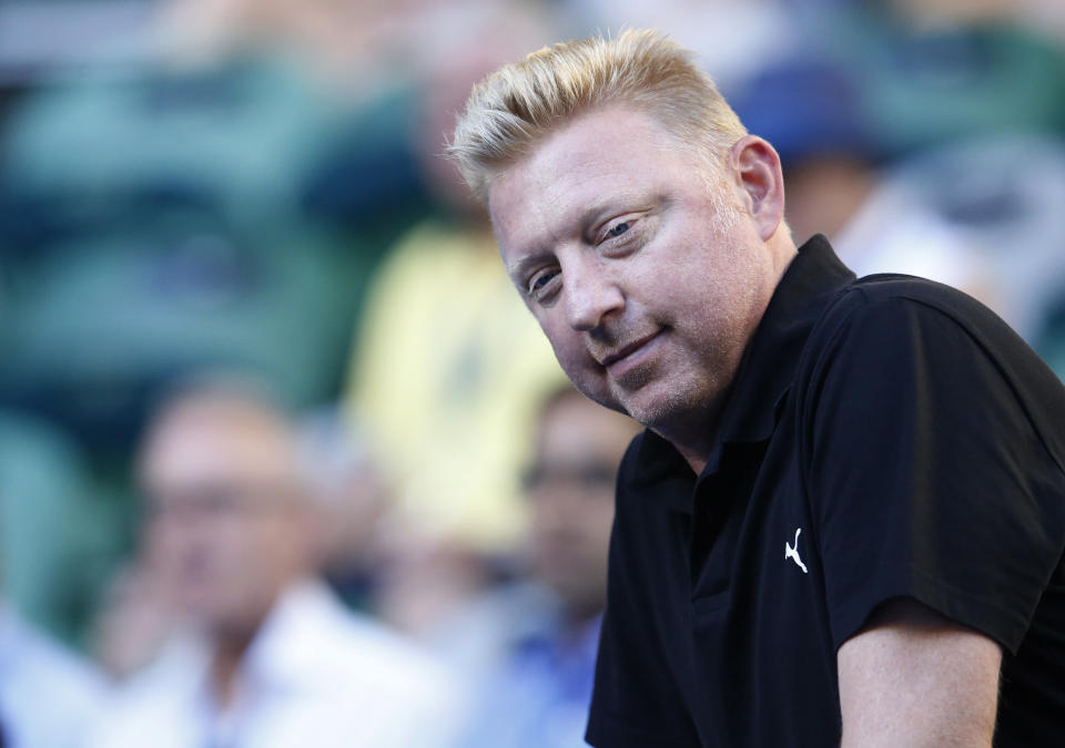 Former Grand Slam champion Boris Becker of Germany looks down onto Rod Laver Arena as he prepares to watch defending champion Novak Djokovic in his match against Slovakia's Lukas Lacko at the Australian Open tennis championship in Melbourne, Australia, Monday, Jan. 13, 2014.(AP Photo/Eugene Hoshiko)