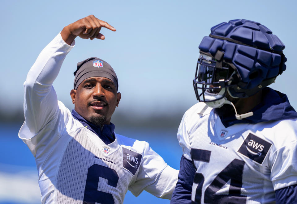 Seattle Seahawks free safety Quandre Diggs (6) points to linebacker Bobby Wagner (54) as fans chant Wagner's name during the NFL football team's training camp Wednesday, July 26, 2023, in Renton, Wash. (AP Photo/Lindsey Wasson)