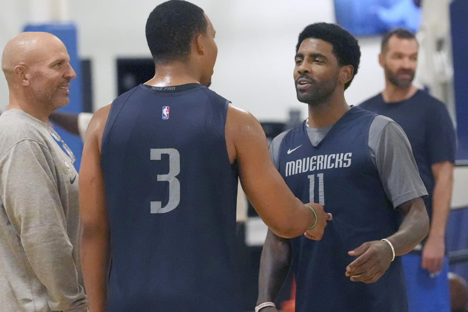 Dallas Mavericks forward Grant Williams (3) jokes with guard Kyrie Irving (11) and head coach Jason Kidd, left, during an NBA basketball training camp in Dallas, Thursday, Sept. 28, 2023. (AP Photo/LM Otero)