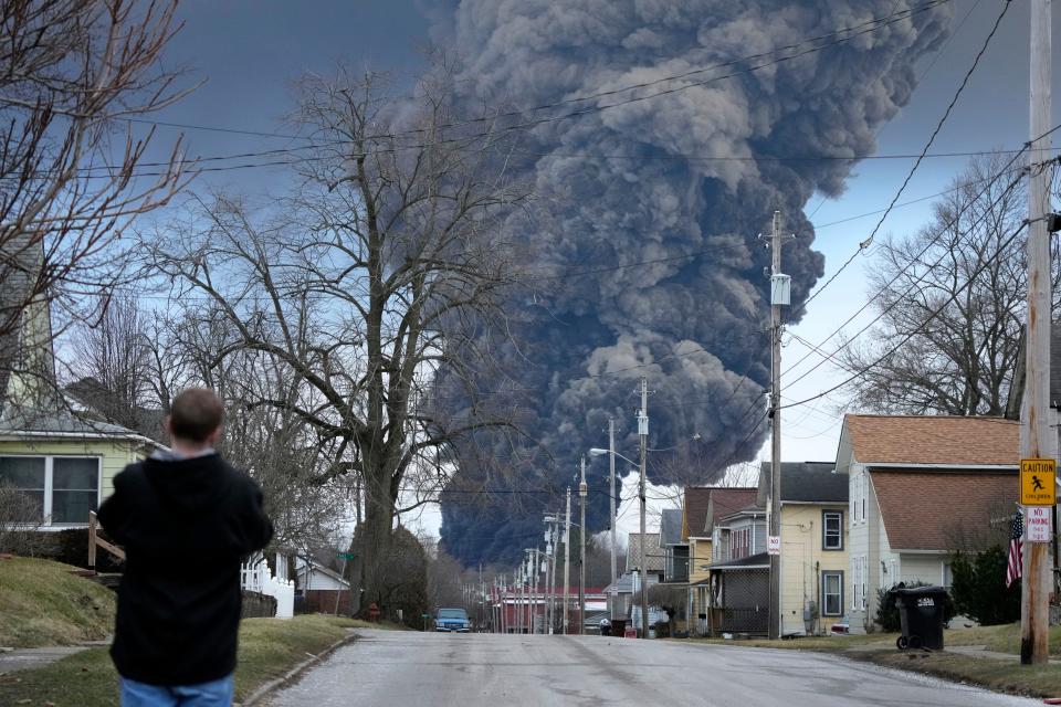 A black plume rises over East Palestine, Ohio, as a result of a controlled detonation of a portion of the derailed Norfolk Southern train on Feb. 6.