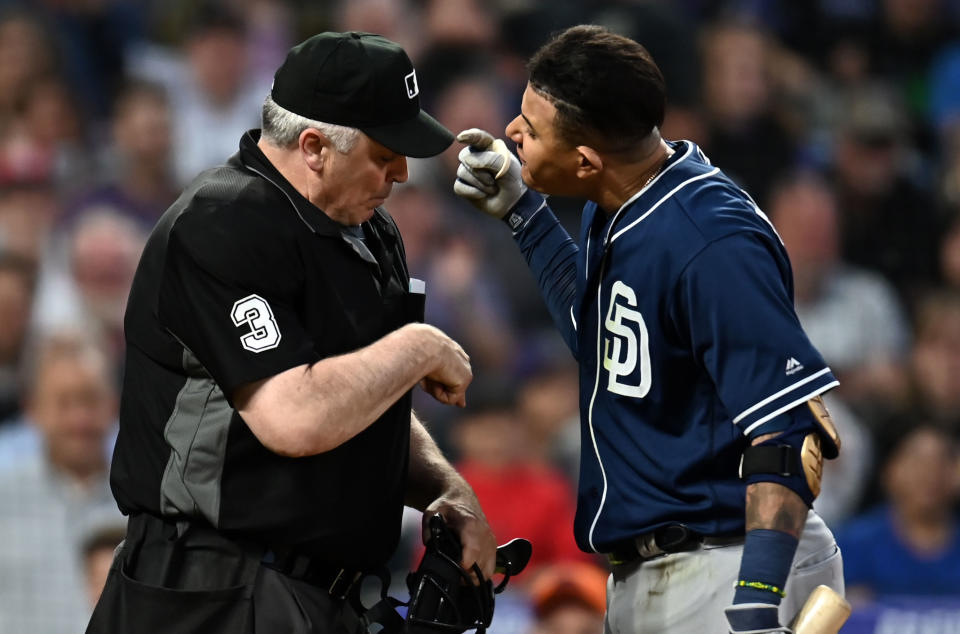 MLB home plate umpire Bill Welke (3) and San Diego Padres shortstop Manny Machado (13) have words following his ejection during the fifth inning against the Colorado Rockies at Coors Field. (Ron Chenoy-USA TODAY Sports)