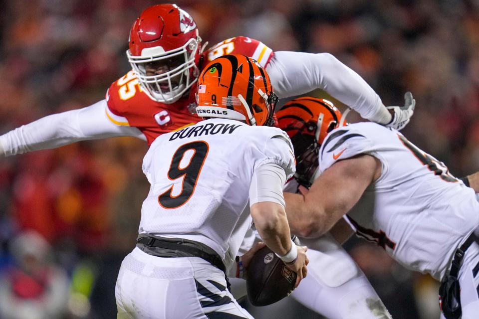 Cincinnati Bengals quarterback Joe Burrow tries to avoid Kansas City Chiefs defensive tackle Chris Jones