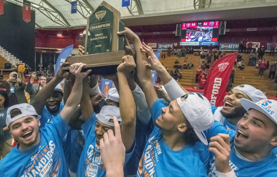 Radford players, from left to right, Caleb Tanner, Carlik Jones, Devonnte Holland, Darius Bolstad and John Caldwell celebrate with the championship trophy. (AP)