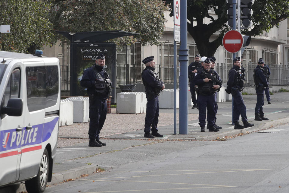 Police officers stand in front the Gambetta high school during bomb alert Monday, Oct. 16, 2023 in Arras, northern France. Schoolchildren and educators will hold a moment of silence in French schools on Monday after a teacher was fatally stabbed and three other people wounded last week in Arras, in an attack by a former student suspected of Islamic radicalization. (AP Photo/Michel Spingler)