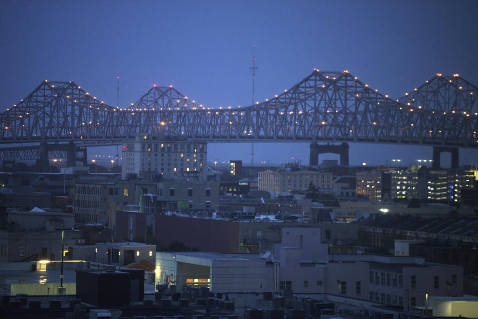 Clouds are seen over the Crescent City Connection bridge at dawn as Tropical Storm Barry approaches in New Orleans, early Saturday, July 13, 2019. (Max Becherer/The Advocate via AP)