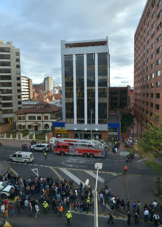 Colombian police and firefighters check the site of an explosion in the financial heart of Bogota on July 2, 2015