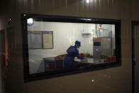 In this Oct. 22, 2018 photo, a worker a worker makes sausages in a production room at Songdowon General Foodstuffs Factory in Wonsan, North Korea. The factory produces cookies, crackers, candies and bakery goods, plus dozens of varieties of soft drinks, that are sold all across the country. North Korean leader Kim Jong Un is waging a campaign to rally the nation behind his economic goals with on-the-spot guidance and calls for managers to step up their game. (AP Photo/Dita Alangkara)