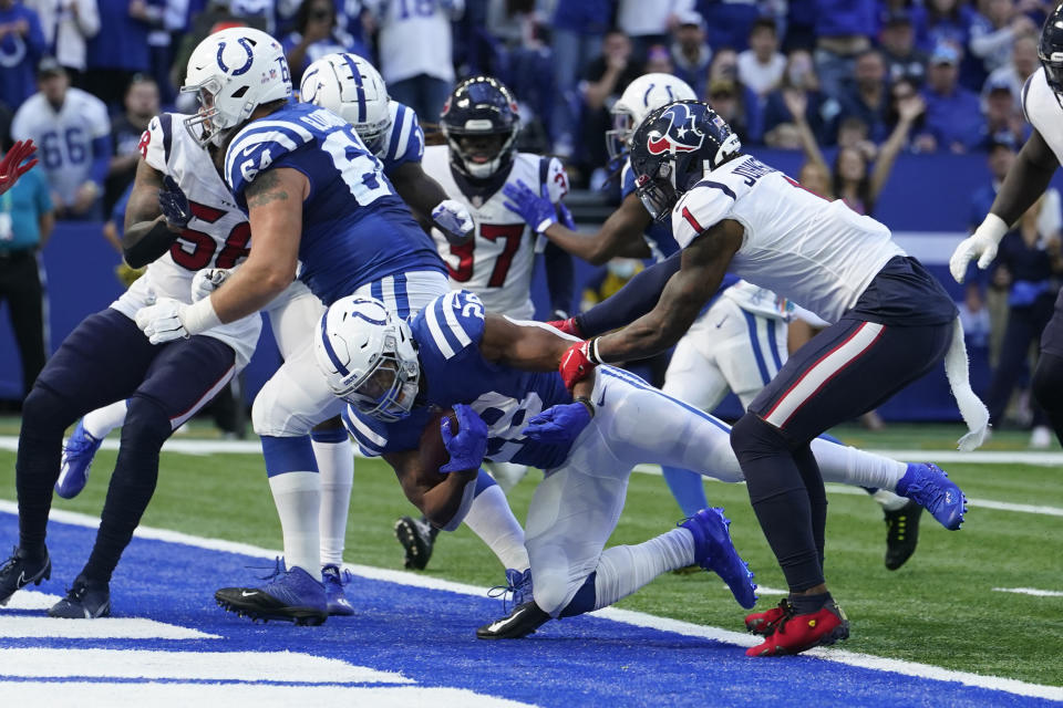 Indianapolis Colts' Jonathan Taylor (28) rushes for a touchdown against Houston Texans' Lonnie Johnson (1) during the second half of an NFL football game, Sunday, Oct. 17, 2021, in Indianapolis. (AP Photo/Michael Conroy)