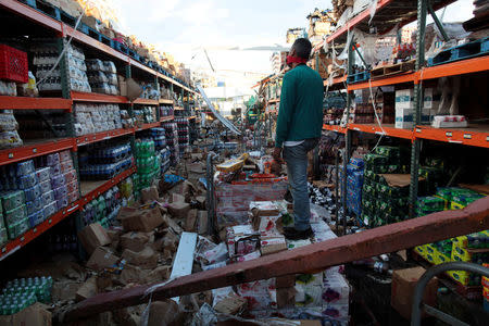 A man stands inside of a destroyed supermarket by Hurricane Maria in Salinas, Puerto Rico, September 29, 2017 REUTERS/Alvin Baez