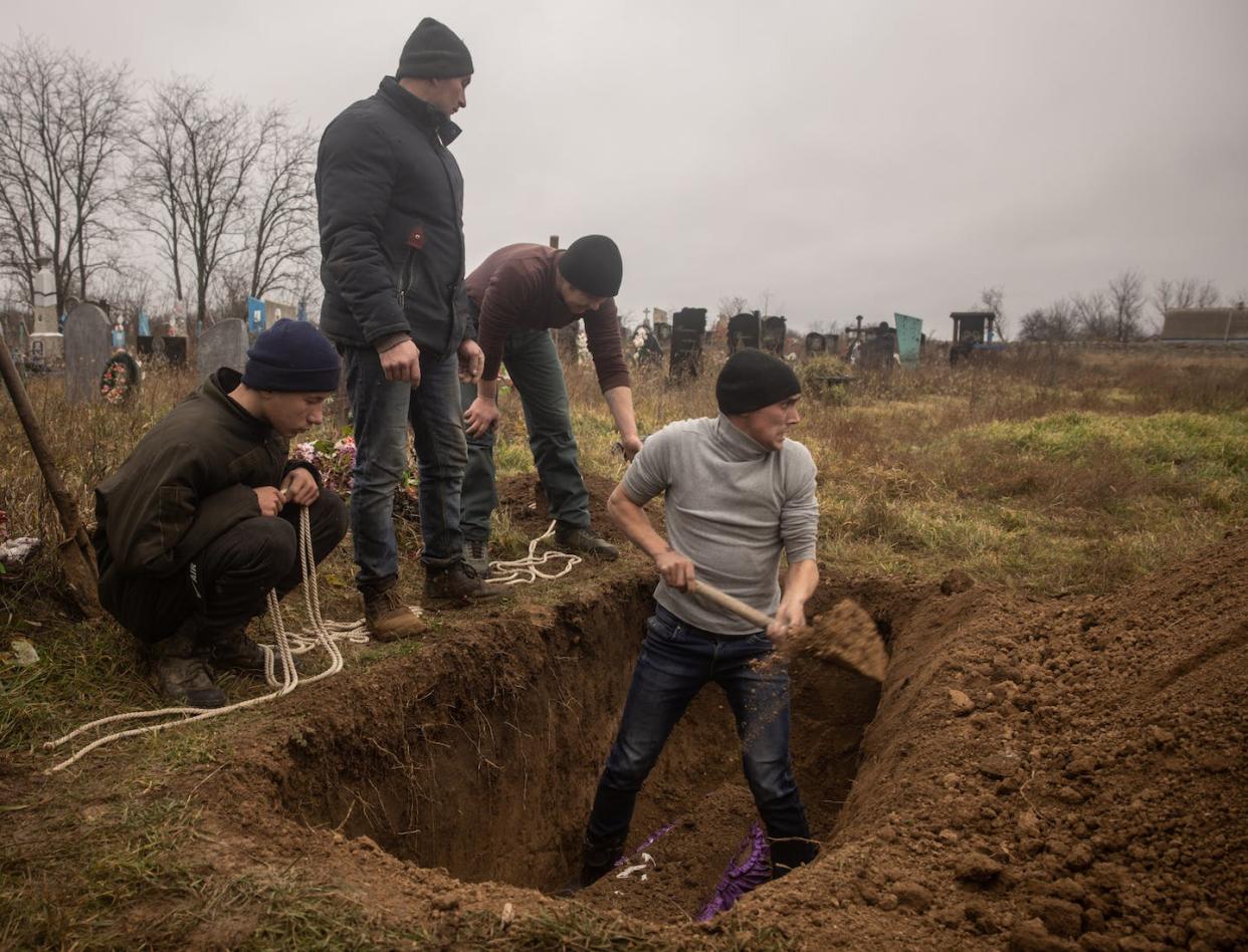 Local residents help exhume the body of a 16-year-old Ukrainian girl, killed by Russian forces, in Kherson, Ukraine in November 2022. <a href="https://media.gettyimages.com/id/1445424692/photo/civilian-graves-exhumed-near-kherson.jpg?s=1024x1024&w=gi&k=20&c=JXbQLd4k0KcIqsM1osHjPq9_OHNE5MhXrFGTQCp63_E=" rel="nofollow noopener" target="_blank" data-ylk="slk:Chris McGrath/Getty Images;elm:context_link;itc:0;sec:content-canvas" class="link ">Chris McGrath/Getty Images</a>