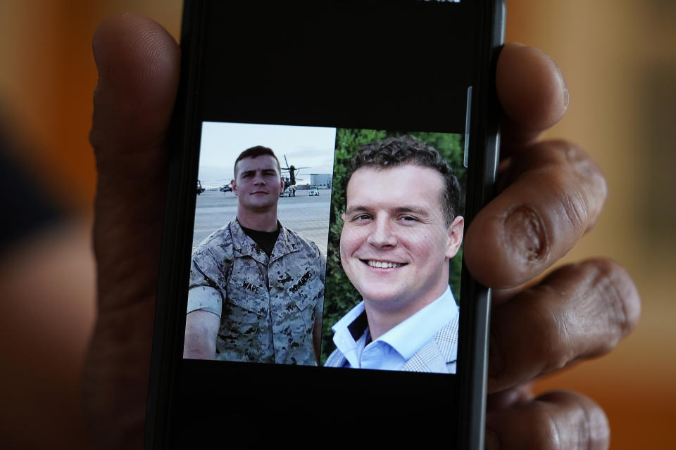 Tom Ware holds photos of his son, Taylor Ware, on his phone in Kansas City, Mo., Tuesday, June 6, 2023. The aspiring college student and former Marine died after a violent encounter with police during a manic episode caused by bipolar disorder. (AP Photo/Charlie Riedel)