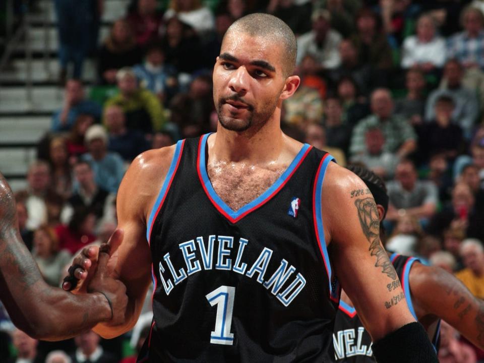 Carlos Boozer shakes hands with a teammate during a game in 2003.