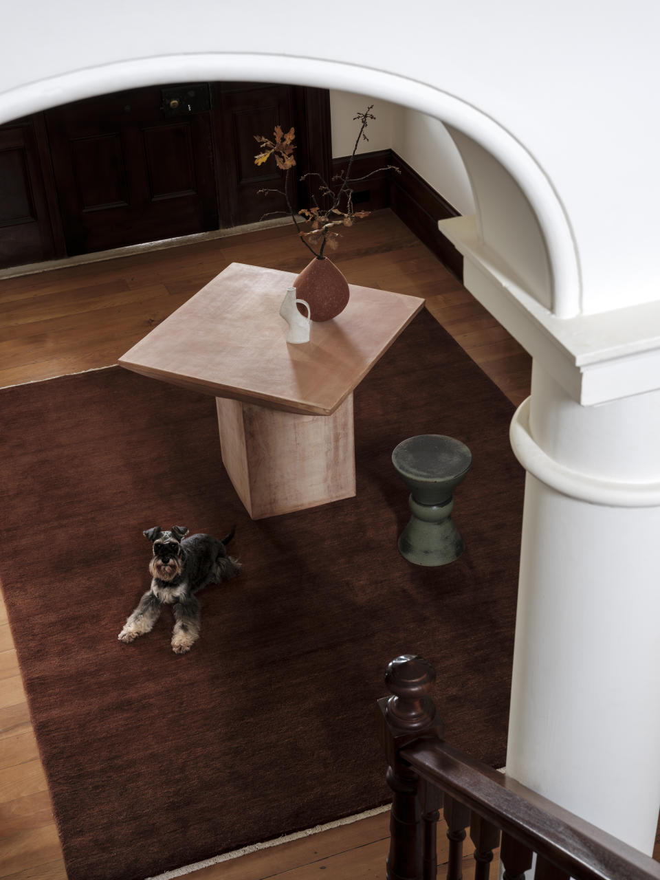 An entryway furnished with a terracotta entryway table