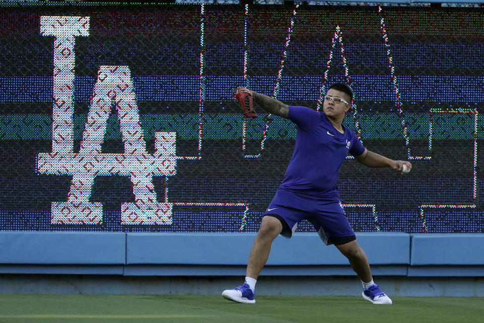 Los Angeles Dodgers starting pitcher Julio Urias warms up during a workout ahead of Game 3 of baseball's National League Championship Series against the Atlanta Braves, Monday, Oct. 18, 2021, in Los Angeles. (AP Photo/Marcio Jose Sanchez)