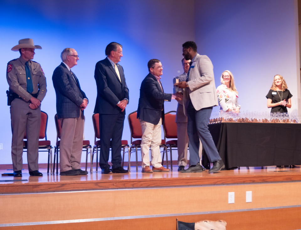 Ryan Francis, coordinator for workforce employer solutions for Amarillo College, accepts his award Thursday at the Texans Caring for Texans ceremony at West Texas A&M University in Canyon.