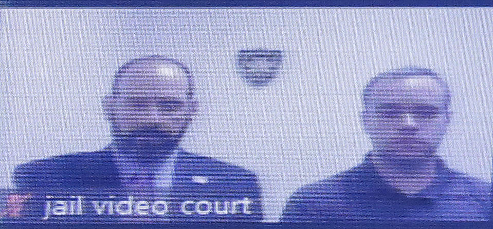 Former Atlanta police Officer Garrett Rolfe, right, appears on a television screen with attorney Lance LoRusso, Tuesday, June 30, 2020, in Atlanta. Rolfe, who fatally shot Rayshard Brooks when Brooks fired a Taser in his direction while running away after a struggle on June 12, can be free on bond while his case is pending. A judge set a bond of $500,000 for Rolfe, who faces charges, including felony murder. (AP Photo/Brynn Anderson, Pool)