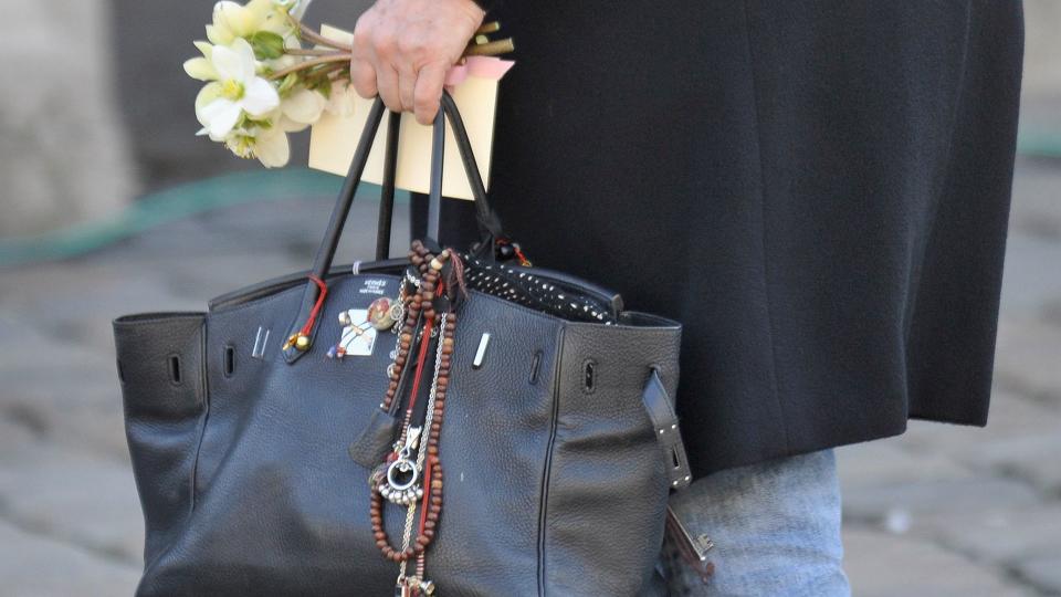 Jane Birkin arrives at the Saint-Germain-des-Pres church wearing one of her infamous decorated bags 