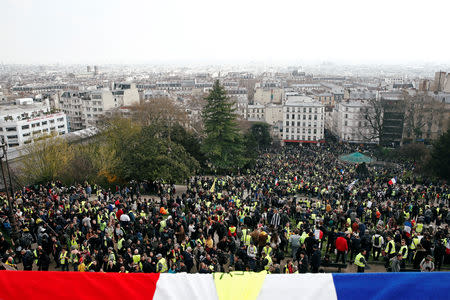 Protesters wearing yellow vests attend a demonstration in front of the Sacre-Coeur Basilica of Montmartre during the Act XIX (the 19th consecutive national protest on Saturday) of the "yellow vests" movement in Paris, France, March 23, 2019. REUTERS/Benoit Tessier