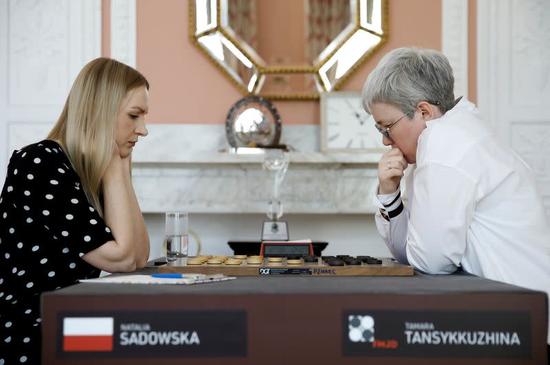 Draught players Polish Natalia Sadowska and Russian Tamara Tansykkuzhina play a game during the Women's World Draughts Championship in Warsaw