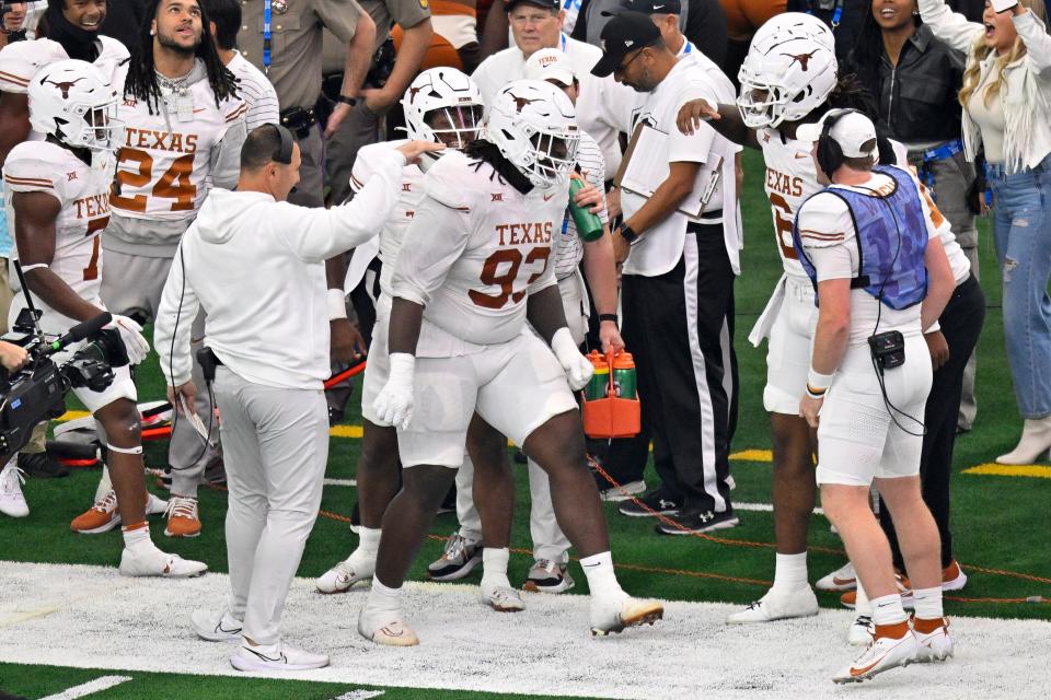 Texas defensive tackle T'Vondre Sweat celebrates his 2-yard touchdown catch against Oklahoma State in the Big 12 championship game. The Big 12 defensive player of the year would go on to win the Outland Trophy as the country's top interior lineman.