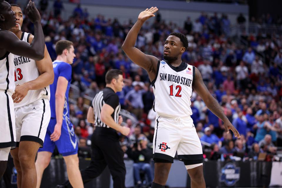 San Diego State  guard Darrion Trammell (12) reacts to a play with teammates during the first half against Creighton during the NCAA men's tournament at KFC YUM! Center.