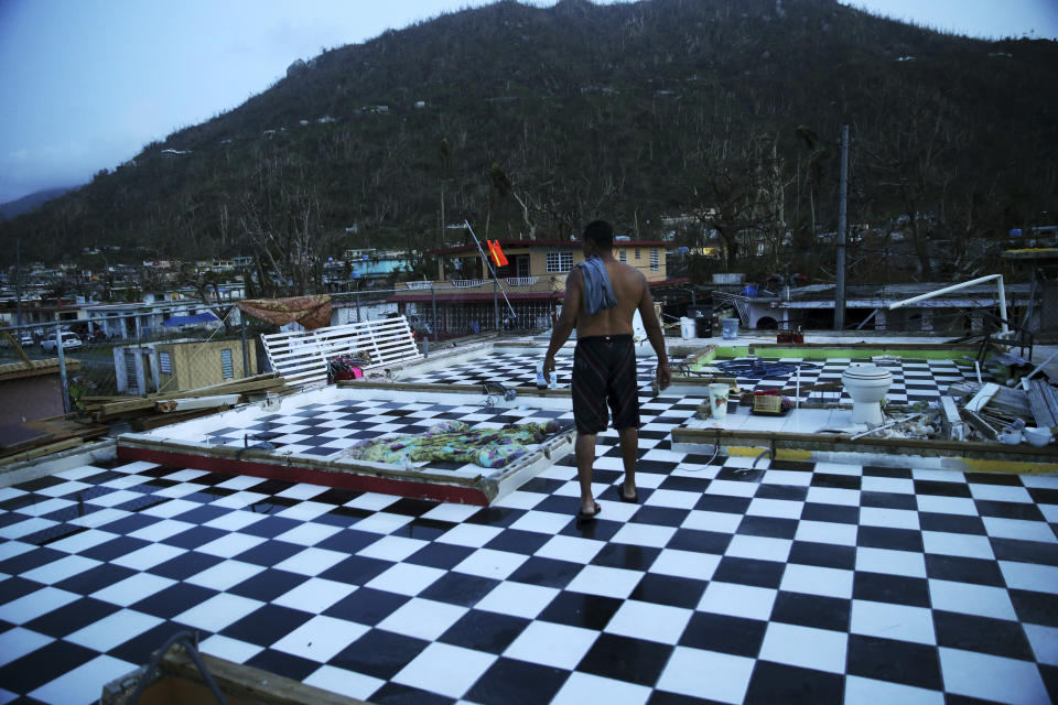 FILE - In this Sept. 26, 2017, file photo, Nestor Serrano walks on the upstairs floor of his home, where the walls were blown off, in the aftermath of Hurricane Maria, in Yabucoa, Puerto Rico. Nasty hurricanes that cause billions of dollars in damage are hitting more often. Laura, which is threatening the U.S. Gulf Coast, is only the latest. (AP Photo/Gerald Herbert, File)