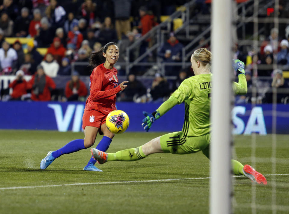 United States forward Christen Press, left, scores past Sweden goalkeeper Hedvig Lindahl during the first half of a women's international friendly soccer match in Columbus, Ohio, Thursday, Nov. 7, 2019. (AP Photo/Paul Vernon)