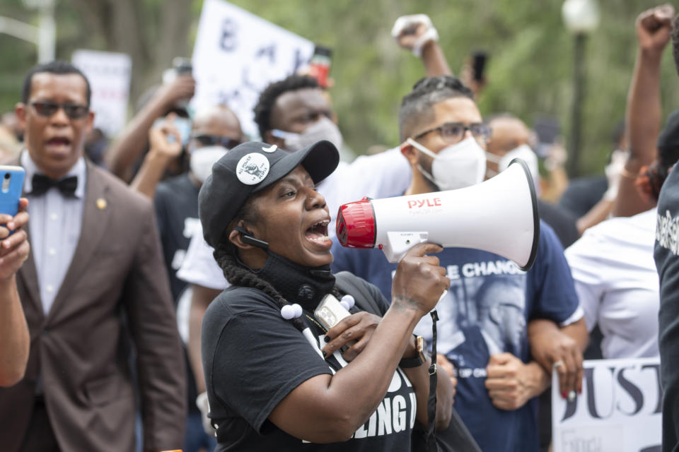 A group of protesters march from the Glynn County Courthouse in downtown to a police station after a rally to protest the shooting of Ahmaud Arbery, Saturday, May 16, 2020, in Brunswick, Ga. (AP Photo/Stephen B. Morton)