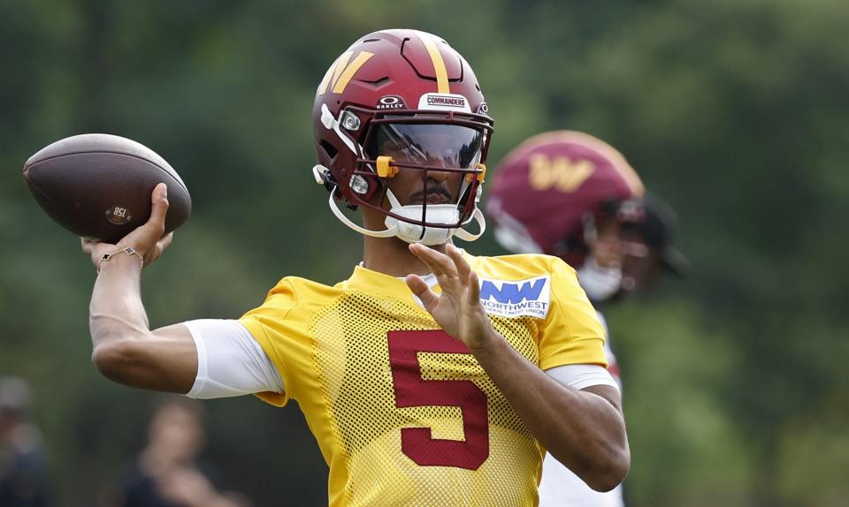 Jul 25, 2024; Ashburn, VA, USA; Washington Commanders quarterback Jayden Daniels (5) passes the ball on day two of training camp at OrthoVirginia Training Center at Commanders Park. Mandatory Credit: Geoff Burke-USA TODAY Sports