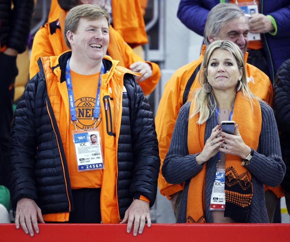 Dutch King Wilem-Alexander, left, and Queen Maxima stand during the flower ceremony for the men's 500-meter speedskating race, where country athletes won the gold, silver and bronze, at the Adler Arena Skating Center at the 2014 Winter Olympics, Monday, Feb. 10, 2014, in Sochi, Russia. (AP Photo/Patrick Semansky)