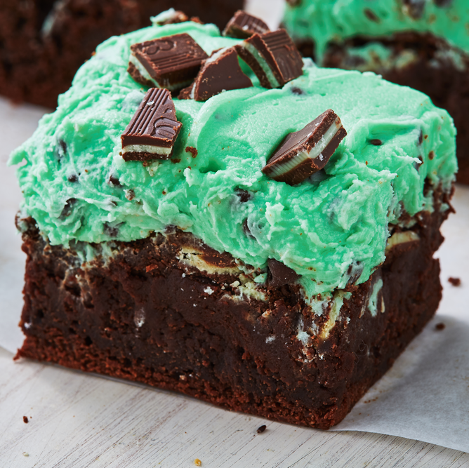 mint chip brownie topped with green frosting and chopped andes chocolate