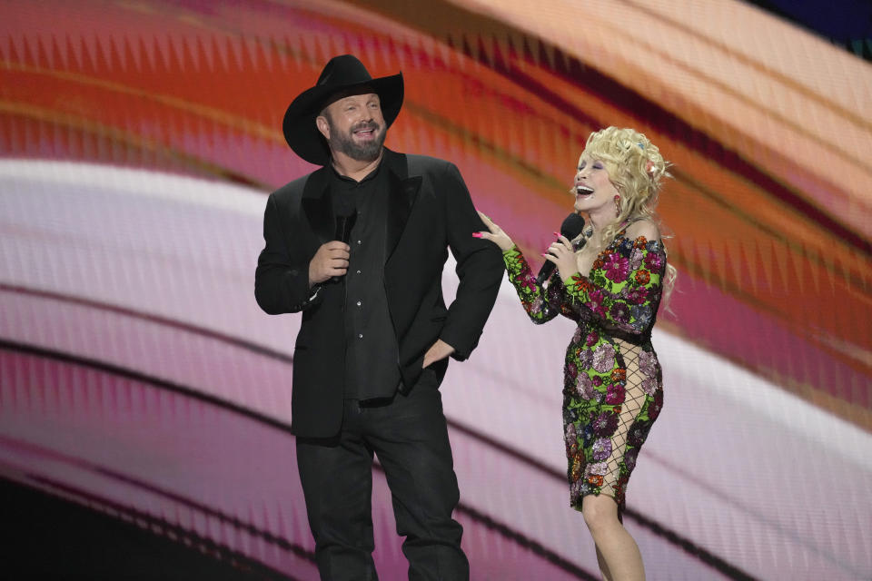 Hosts Garth Brooks, left, and Dolly Parton speak at the 58th annual Academy of Country Music Awards on Thursday, May 11, 2023, at the Ford Center in Frisco, Texas. (AP Photo/Chris Pizzello)