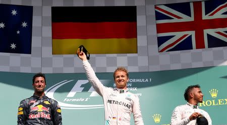 Belgium Formula One - F1 - Belgian Grand Prix 2016 - Francorchamps, Belgium - 28/8/16 - Mercedes' Nico Rosberg of Germany (C) celebrates on the podium with Mercedes' Lewis Hamilton of Britain (R) and Red Bull's Daniel Ricciardo of Australia (L) after the Belgian F1 Grand Prix. REUTERS/Yves Herman