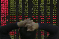 A man monitors shares prices at a brokerage house in Beijing, Tuesday, Jan. 22, 2019. Asian markets were mostly lower on Tuesday after the International Monetary Fund trimmed its global outlook for 2019 and 2020. This came after China said its economy grew at the slowest pace in 30 years. (AP Photo/Andy Wong)