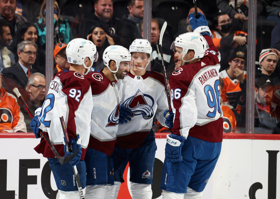 PHILADELPHIA, PA - DECEMBER 06: Cale Makar #8 of the Colorado Avalanche celebrates his first period power-play goal against the Philadelphia Flyers with Gabriel Landeskog #92, Nazem Kadri #91, and Mikko Rantanen #96 at the Wells Fargo Center on December 6, 2021 in Philadelphia, Pennsylvania.  (Photo by Len Redkoles/NHLI via Getty Images)