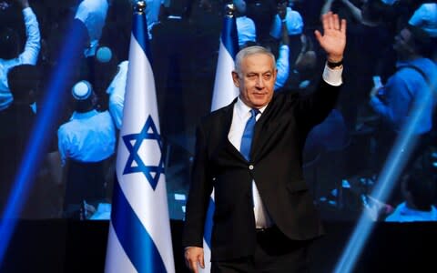 Israeli Prime Minister Benjamin Netanyahu waves to supporters at the Likud party headquarters  - Credit: Reuters