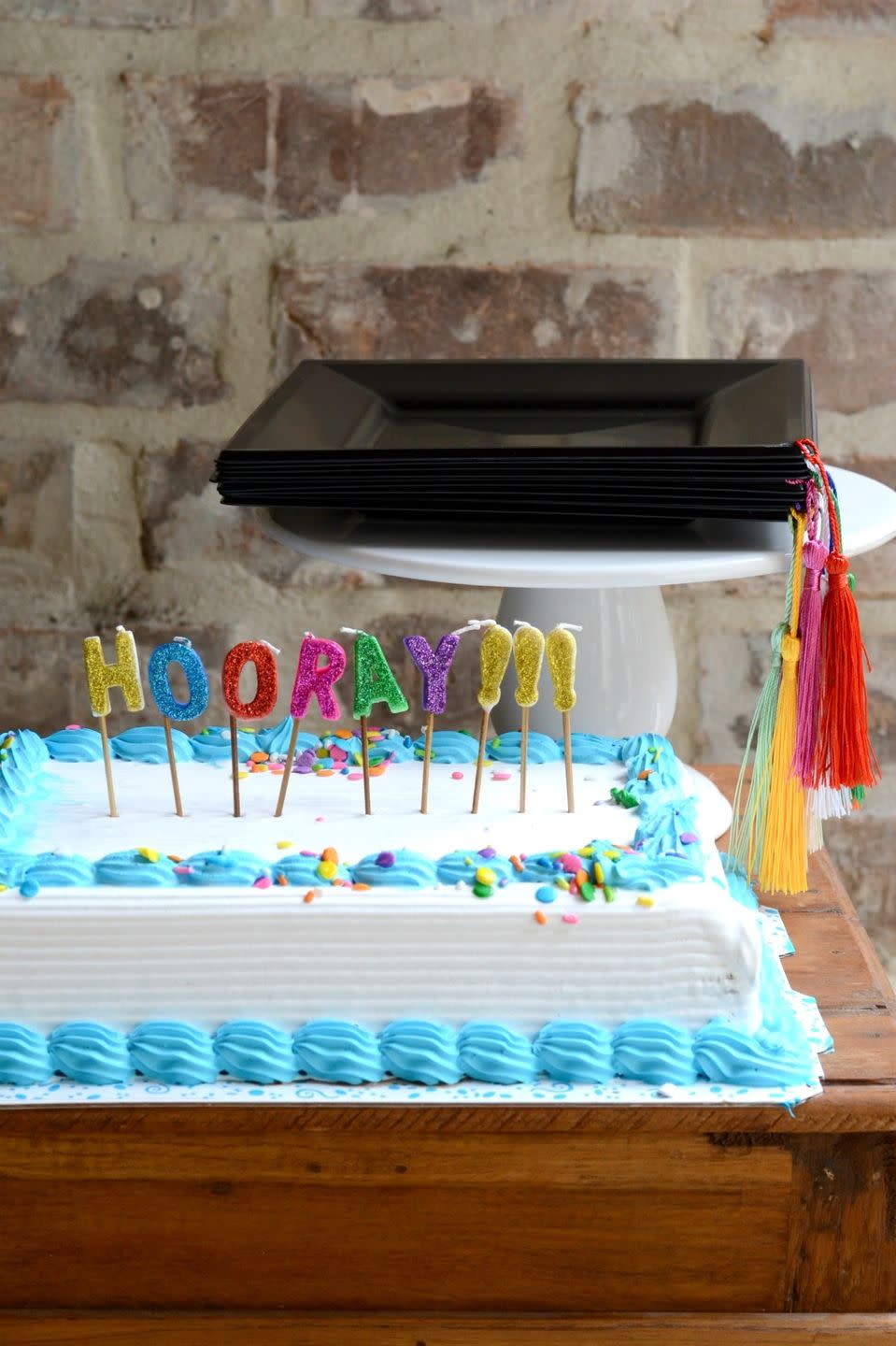 graduation cake with plates in the shape of motarboards and tassels